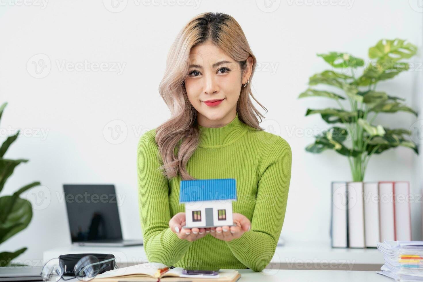 woman sitting on cozy sofa and planning and calculate expense and mortgage with calculator and home on desk insurance and budget of residential loan and residence business and property concept photo